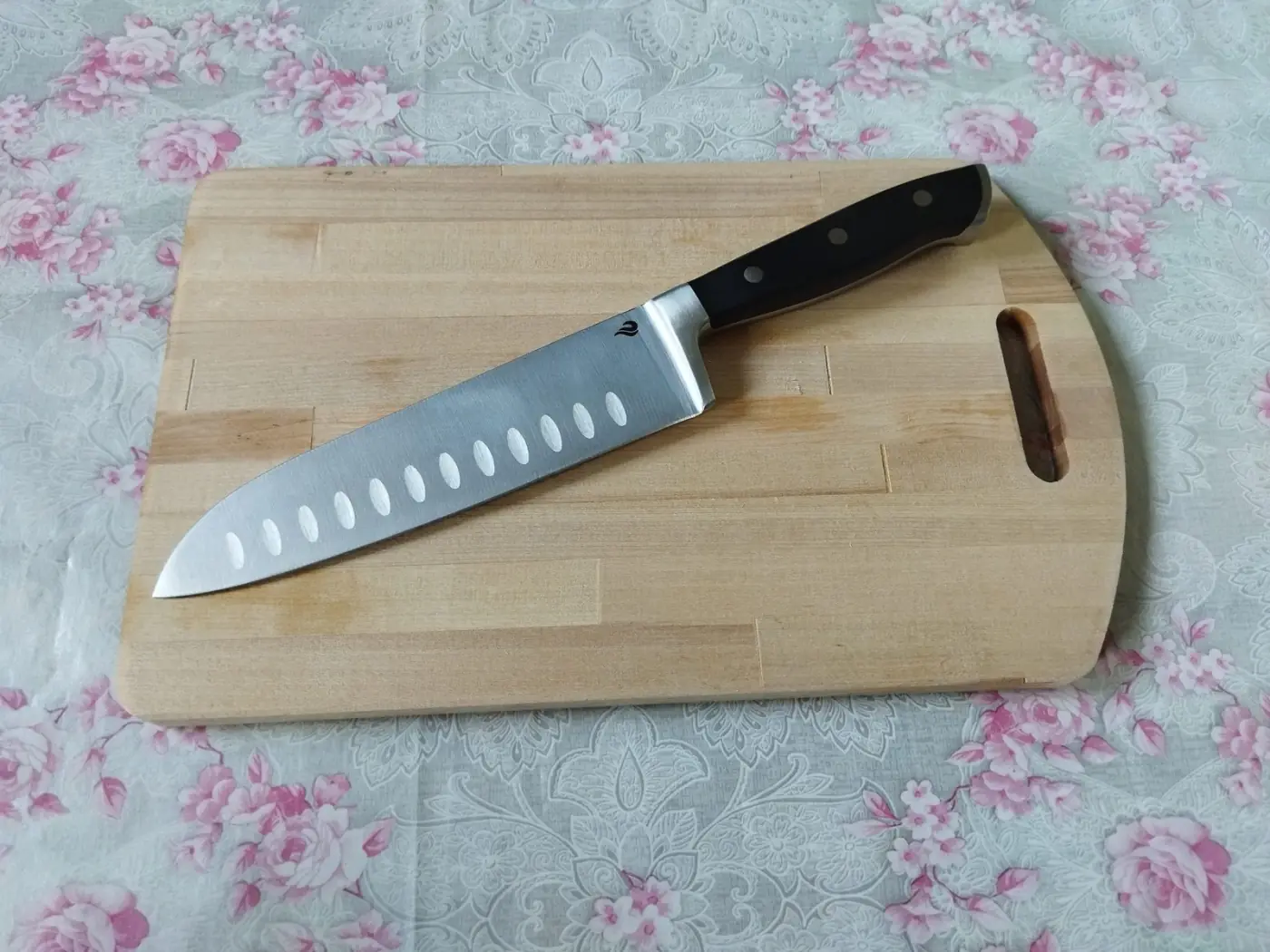 Close-up of the chef knife's edge and wooden handle